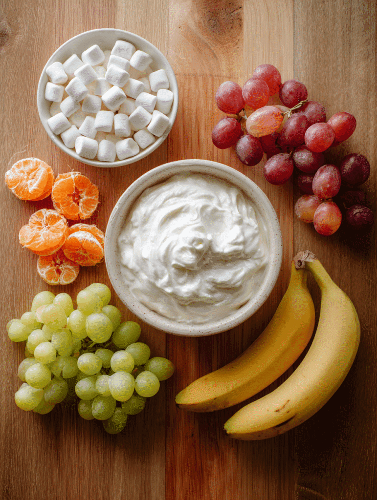 ingredients for fruit salad with Cool Whip, marshmallows, and fruit